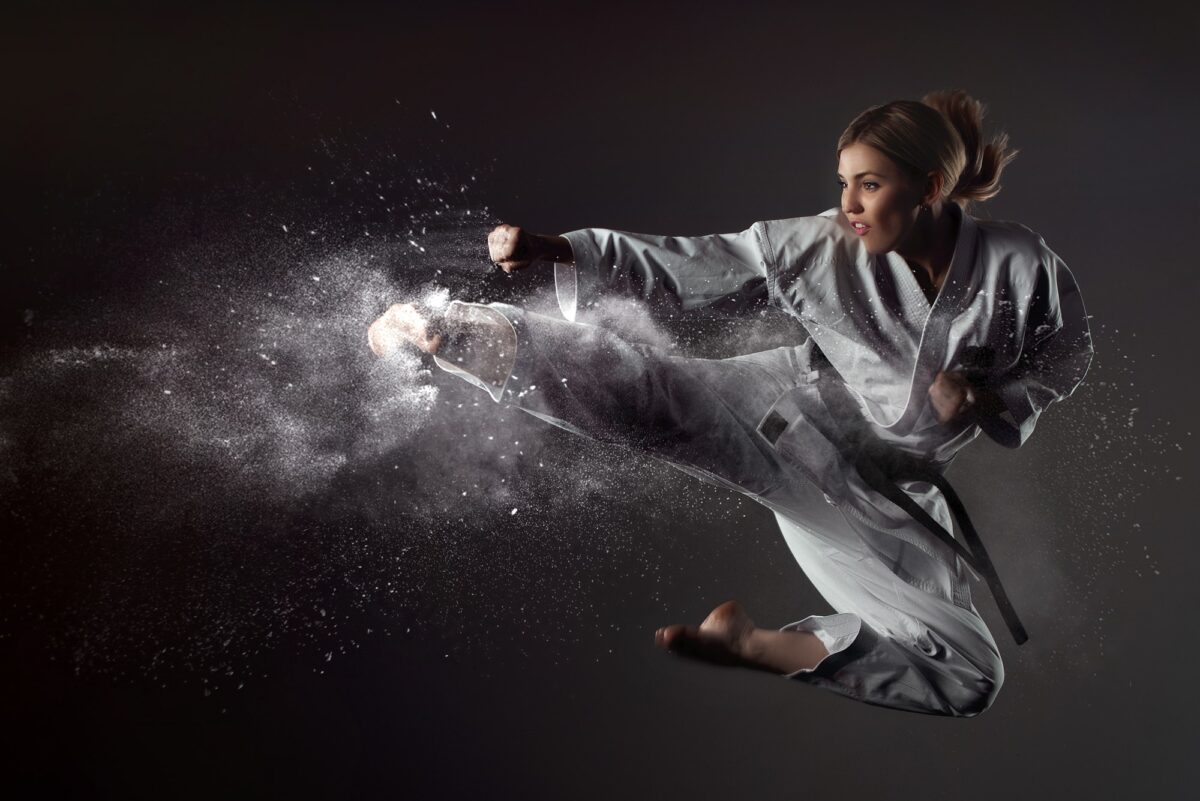 Karate girl Jump Kick stock