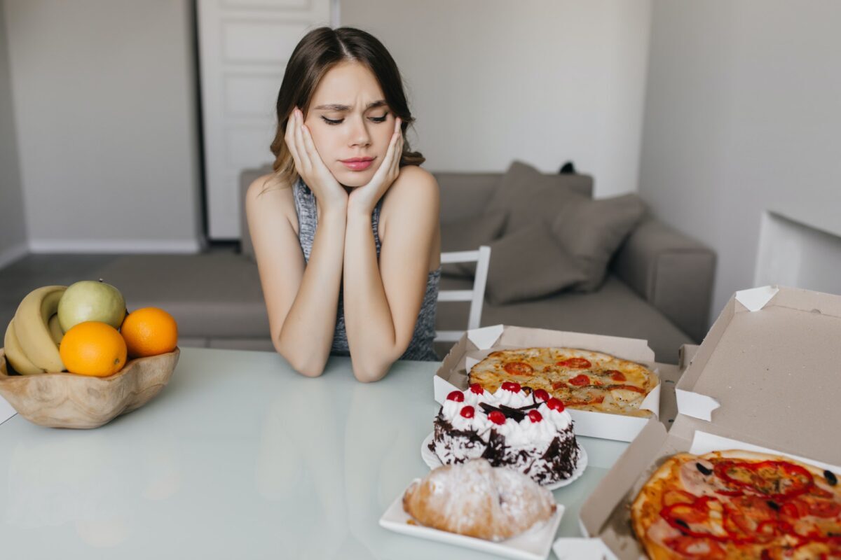 Sad woman looking at cake